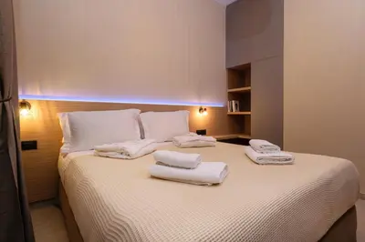 a bedroom with a bed with towels on it at Effrosini Panorama View in Nopíyia