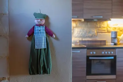 a statue of a chef hanging on a wall in a kitchen at SpiliaInn in Spiliá