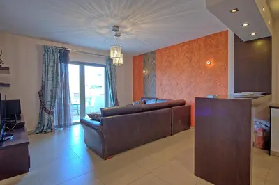 a living room with a couch and a table at Cabanavillas Rio by PosarelliVillas in Agia Marina Nea Kydonias