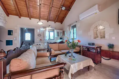 a living room with a couch and a table at Villa Despanto by PosarelliVillas in Litsárdha