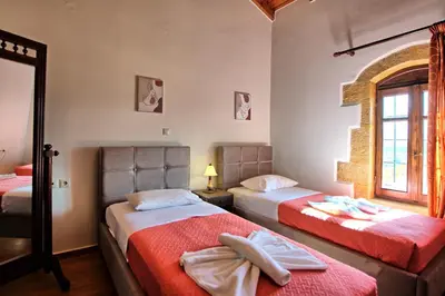 a bedroom with two beds and a window at Villa Sevi Grande by PosarelliVillas in Káto Vení