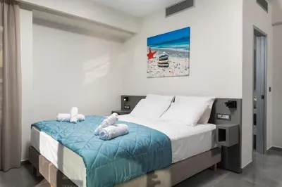 a bedroom with a bed with towels on it at Archin Boutique suites in Chania Town