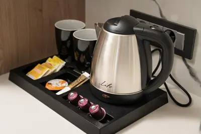 a tea kettle on a black tray on a counter at Archin Boutique suites in Chania Town