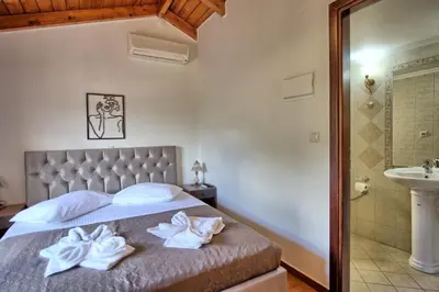 a bedroom with a bed with towels on it at Villa Romantic Sevi by PosarelliVillas in Káto Vení