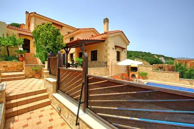 a house with a staircase in front of a house at Villa Romantic Sevi by PosarelliVillas in Káto Vení