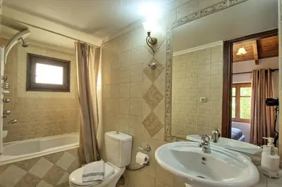 a bathroom with a sink and a toilet at Villa Romantic Sevi by PosarelliVillas in Káto Vení