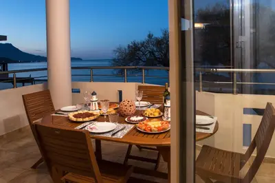 a table with food on top of a balcony at Armonia in Kissamos