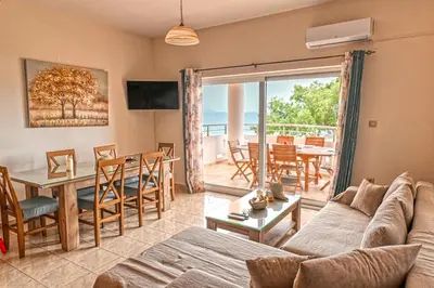 a living room with a couch and a table at Armonia in Kissamos