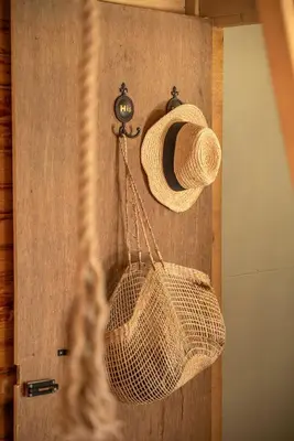 a rattan basket hanging on a wall at Wooden House Apts - Between Balos & Elafonissi in Kaláthenai