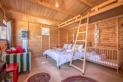 a bedroom with a bunk bed in a log cabin at Wooden House Apts - Between Balos & Elafonissi in Kaláthenai