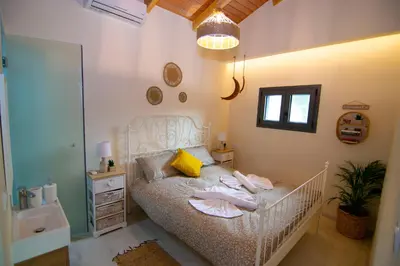 a bedroom with a crib with towels on it at Ampelos Cretan Villa - Private Pool & Heated Ozone Jacuzzi in Gerolakkos