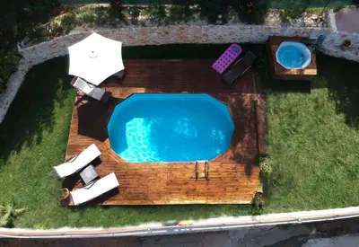 an overhead view of a swimming pool with a deck and chairs at Ampelos Cretan Villa - Private Pool & Heated Ozone Jacuzzi in Gerolakkos