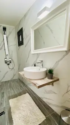 a bathroom with a sink and a mirror at Ampelos Cretan Villa - Private Pool & Heated Ozone Jacuzzi in Gerolakkos