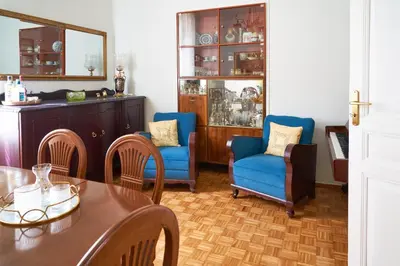 a dining room with blue chairs and a table at Philoxenia Residence Chania City Centre in Chania Town