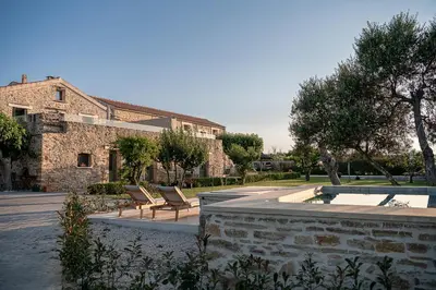 a house with two chairs and a swimming pool at Ondathaki Pirgos in Pírgos Psilonérou