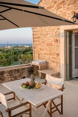 a table with a bowl of fruit on a patio at Ondathaki Pirgos in Pírgos Psilonérou