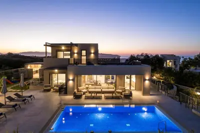 a villa with a swimming pool at night at Imperium Luxury Villas-Sauna, Jacuzzi, Heated Pool & Gym-Chania in Kato Galatas