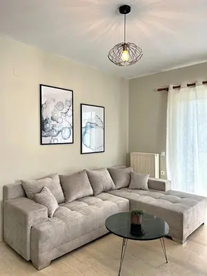 a living room with a couch and a table at Nidus 101 in Souda