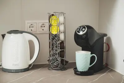 a kitchen counter with a coffee maker and a blender at Aquadia Beach Apartment in Chania Town