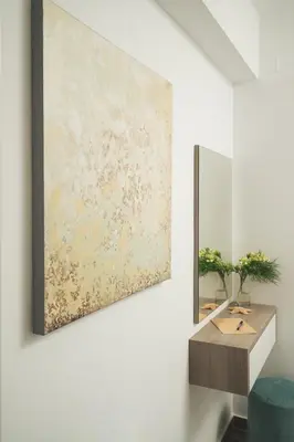 a painting hanging on a wall next to a desk at Aquadia Beach Apartment in Chania Town