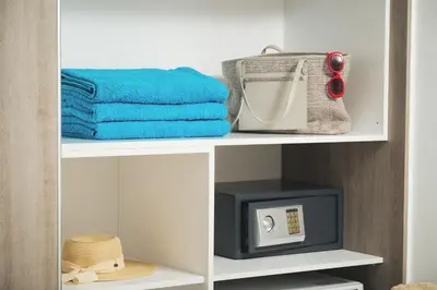 a white shelf with a microwave and a television at Aquadia Beach Apartment in Chania Town
