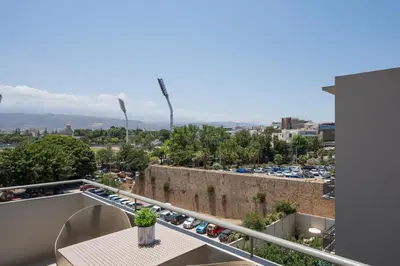 a balcony with a table and a view of a city at Urban Residences Chania in Chania Town