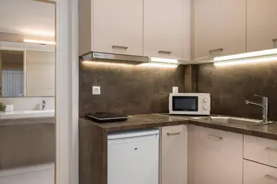 a kitchen with a sink and a microwave at Urban Residences Chania in Chania Town