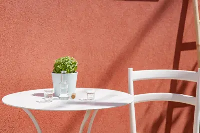 a white table with a plant and two glasses on it at Mouse House with Sea View and Mini Pool in Plataniás