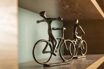 a statue of a man riding a bike on a shelf at Luxury TreeHouse - A breath away from the beach in Loutrákion