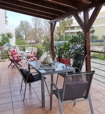a table and chairs sitting on a patio at Cozy Home (close to the beach) in Agia Marina Nea Kydonias