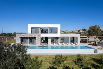 a villa with a swimming pool in front of it at Villa al Sur in Chania Town