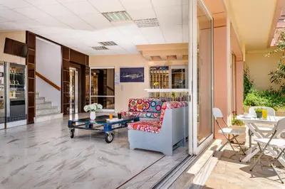 a living room with a couch and a table at Louladakis Apartments in Kolymvari
