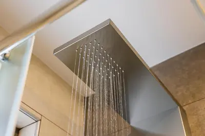 a shower with water dripping down the side of a staircase at INDIGO BLUE Seaside Deluxe Apartments in Kissamos