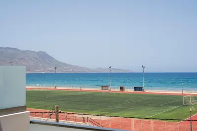a soccer field with the ocean in the background at INDIGO BLUE Seaside Deluxe Apartments in Kissamos