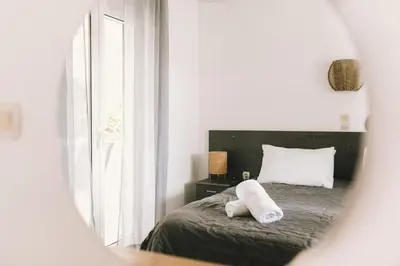 a bedroom with a bed with two towels on it at Grey House in Chorafakia