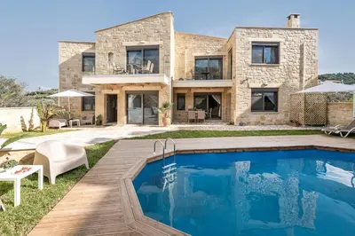 a house with a swimming pool in front of it at Villa Vanka in Chania Town