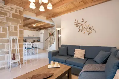 a living room with a blue couch and a table at Villa Vanka in Chania Town