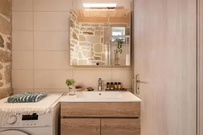 a bathroom with a sink and a washing machine at Villa Vanka in Chania Town