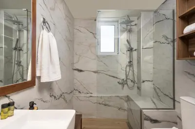 a bathroom with a shower and a sink at Dreamy View Inn in Chania Town
