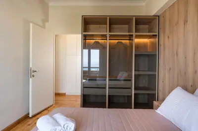 a bedroom with a bed and a glass door at Dreamy View Inn in Chania Town