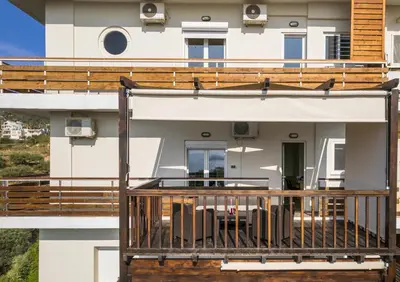 a balcony of a house with wooden railing at Dreamy View Inn in Chania Town