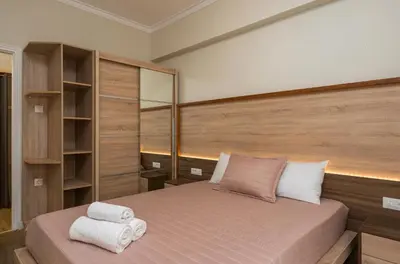 a bedroom with a bed with a wooden headboard at Dreamy View Inn in Chania Town