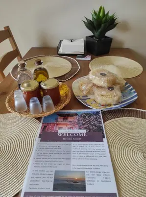 a table topped with plates of donuts and a magazine at Stefanis traditional house - Kampos in Kámbos
