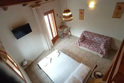 a view of a living room with a couch and a television at Stefanis traditional house - Kampos in Kámbos