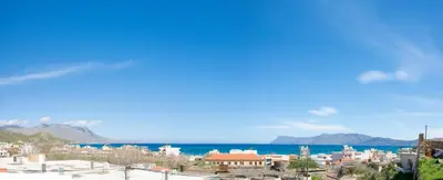 a city with the ocean in the background at Castel View Experience in Kissamos