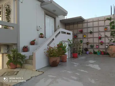 a stairway with potted plants on a building at Castel View Experience in Kissamos