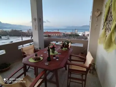 a table on a balcony with a view at Castel View Experience in Kissamos