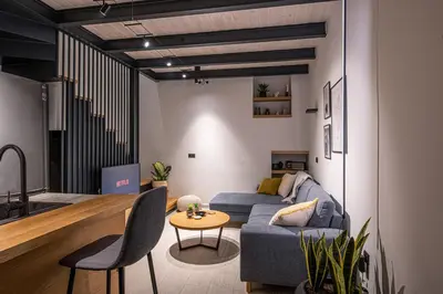 a living room with a blue couch and a table at Chania Residence - City centre maisonette in Chania Town