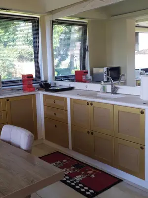a kitchen with a sink and two windows at Aphrodite View in Korakiaí