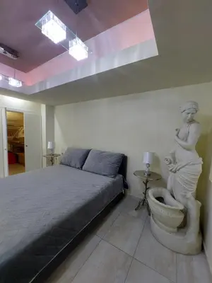 a bedroom with a bed and a statue of a woman at Aphrodite View in Korakiaí